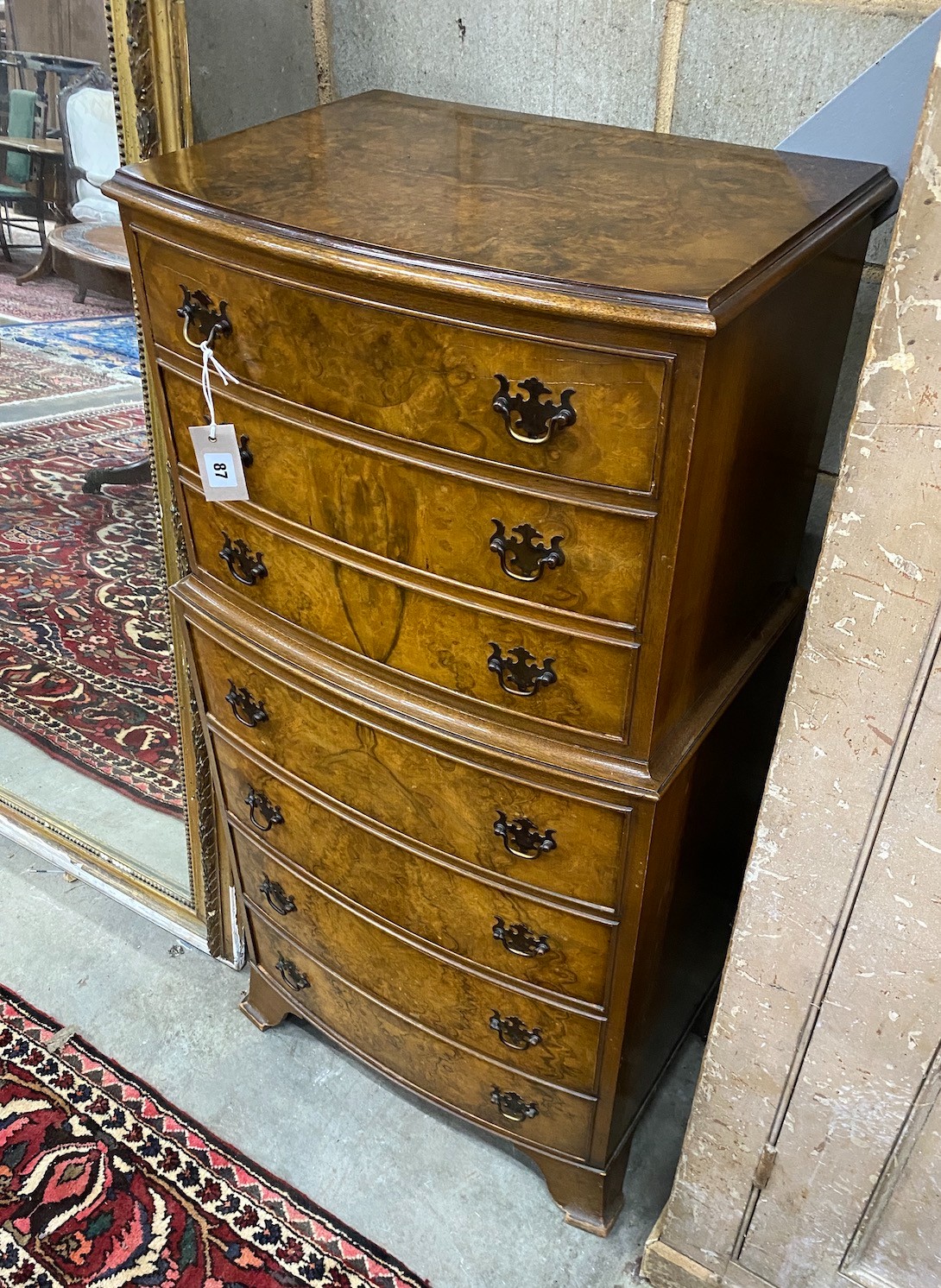 A small Queen Anne style walnut seven drawer bow front chest, width 54cm, depth 38cm, height 110cm